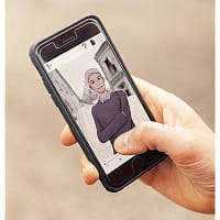 A closeup of a man's hand holding a smartphone. On the screen, an animated character is visible