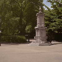 Outside Lincoln's Inn Park, with trees in the background and a fountain in the foreground