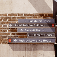 A sign on a brick wall that says Pankhurst house