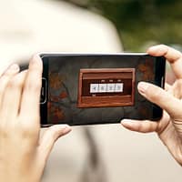 The screen of a smartphone, showing a cipher puzzle where you are supposed to guess four numbers.