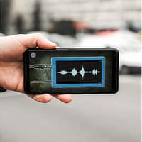 A close up photo of a smartphone. There is an illustration of sound waves on the screen.