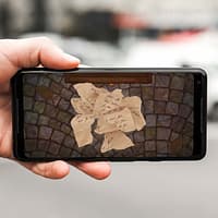 A hand is holding a mobile phone. On the screen is an illustration of a torn letter.
