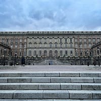 A photo of the Royal Palace in Stockholm, photographed from the waterfront. It's a big, grey stone building.