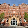 A photo of a large, imposing red brick building