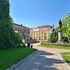 A photo of the University park in Uppsala on a sunny day. yo ucan see the Carolina library in the background.