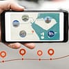 Photo of a mobile phone on location showing a map with interactions