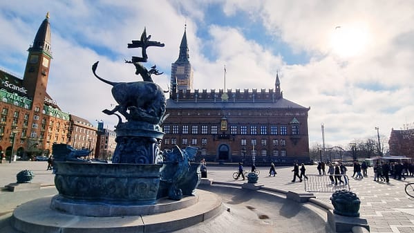 A photo of Rådhuspladsen sqaure in Copenhagen, with the imposing city hall building in the background.