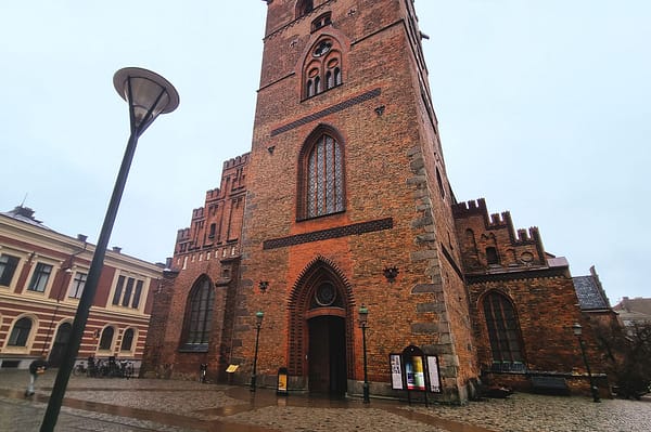 A photo of the St Petri church in Malmö. It's a big red brick building with a gothic look.