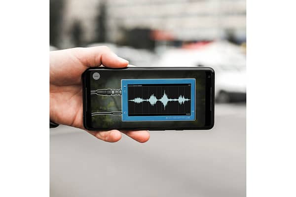 A close up photo of a smartphone. There is an illustration of sound waves on the screen.