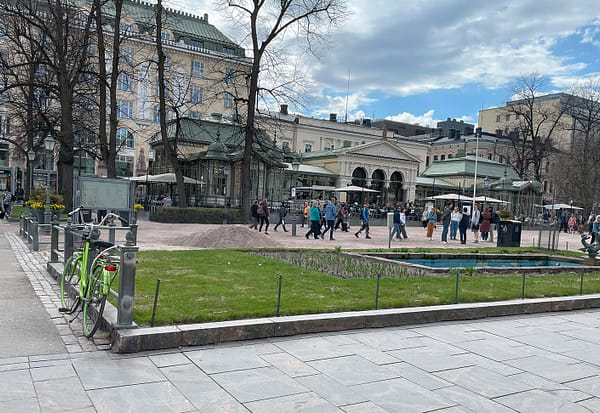 A photo of a small park in Helsinki, with a little pond in the foreground