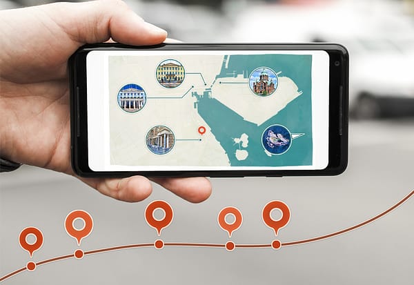 Photo of a mobile phone on location showing a map with interactions