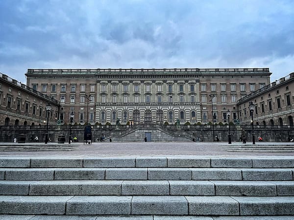 A photo of the Royal Palace in Stockholm, photographed from the waterfront. It's a big, grey stone building.