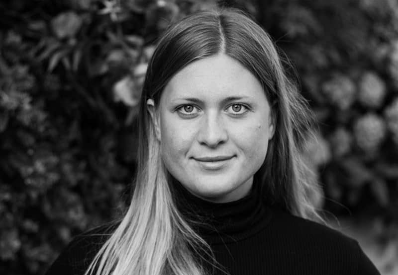 A black and white portrait image of Maria Lundin Osvalds. She is looking straight at the camera.